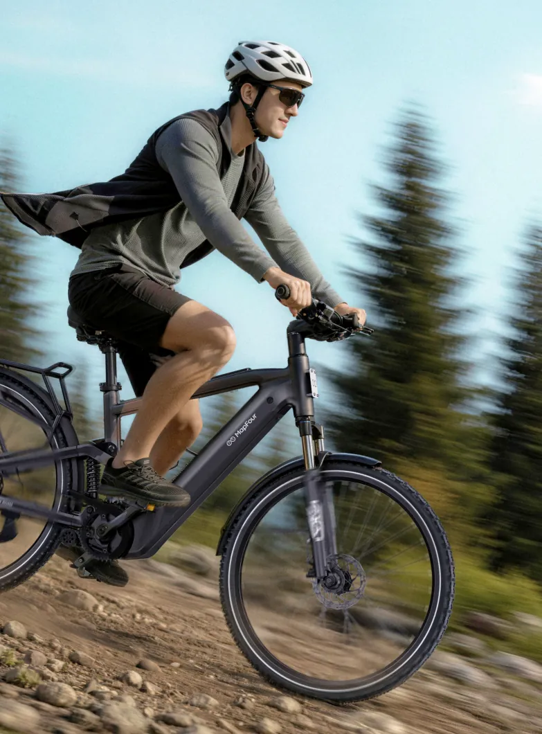 Cyclist riding a MapFour Roam downhill on a trail